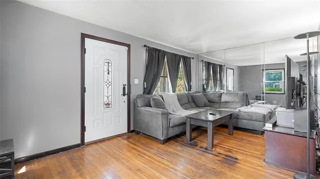 a living room with furniture window and wooden floor
