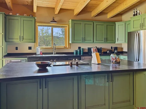 a kitchen with a sink and a large window
