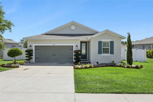 a front view of a house with a yard and garage