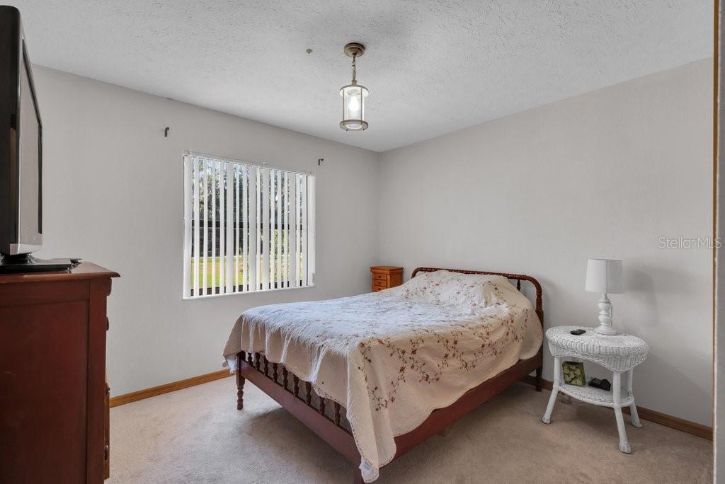 5301 Coronet Road Plant City, FL 33566 - Photo 13 of 38 a bedroom with a bed and a window