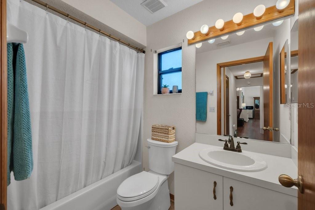 5301 Coronet Road Plant City, FL 33566 - Photo 15 of 38 a bathroom with a sink a toilet and mirror