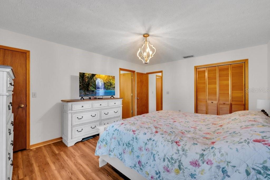 5301 Coronet Road Plant City, FL 33566 - Photo 17 of 38 a bedroom with a bed and a flat screen tv