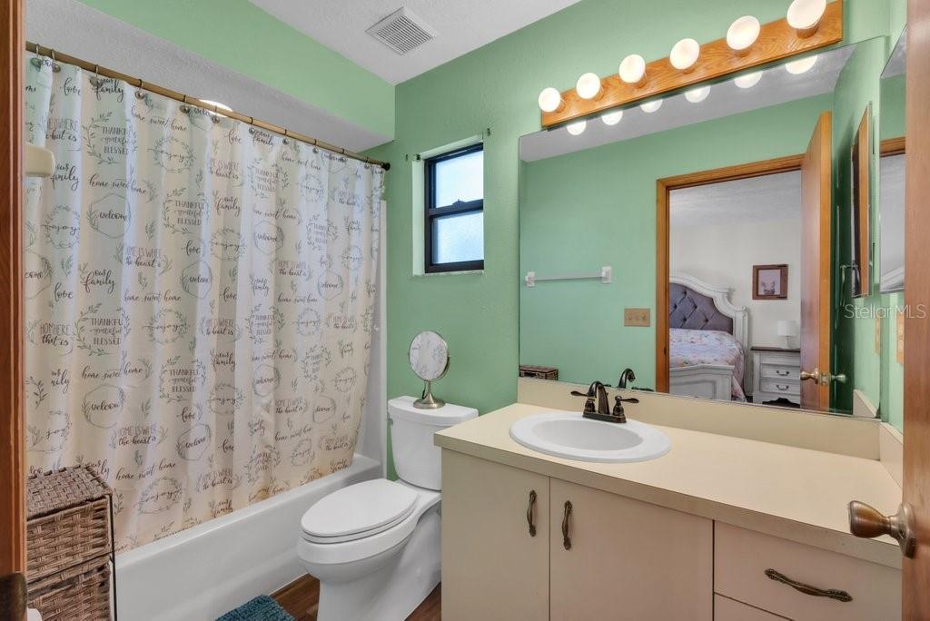 5301 Coronet Road Plant City, FL 33566 - Photo 18 of 38 a bathroom with a granite countertop sink a toilet and a mirror