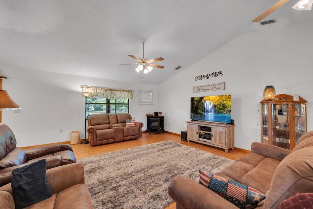 5301 Coronet Road Plant City, FL 33566 - Photo 19 of 38 a living room with furniture and a flat screen tv