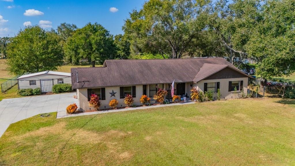 5301 Coronet Road Plant City, FL 33566 - Photo 2 of 38 a front view of a house with a yard