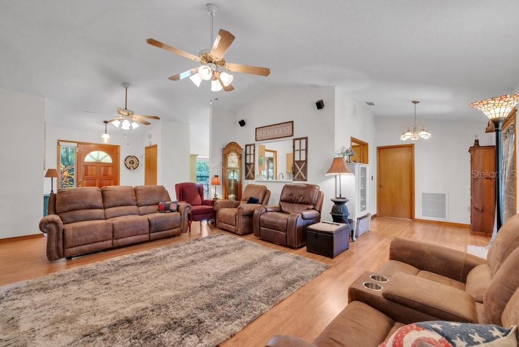 5301 Coronet Road Plant City, FL 33566 - Photo 21 of 38 a living room with furniture a chandelier and a couch