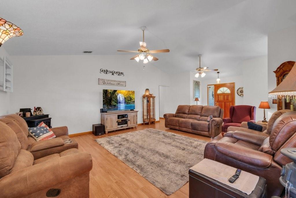 5301 Coronet Road Plant City, FL 33566 - Photo 22 of 38 a living room with furniture and a flat screen tv