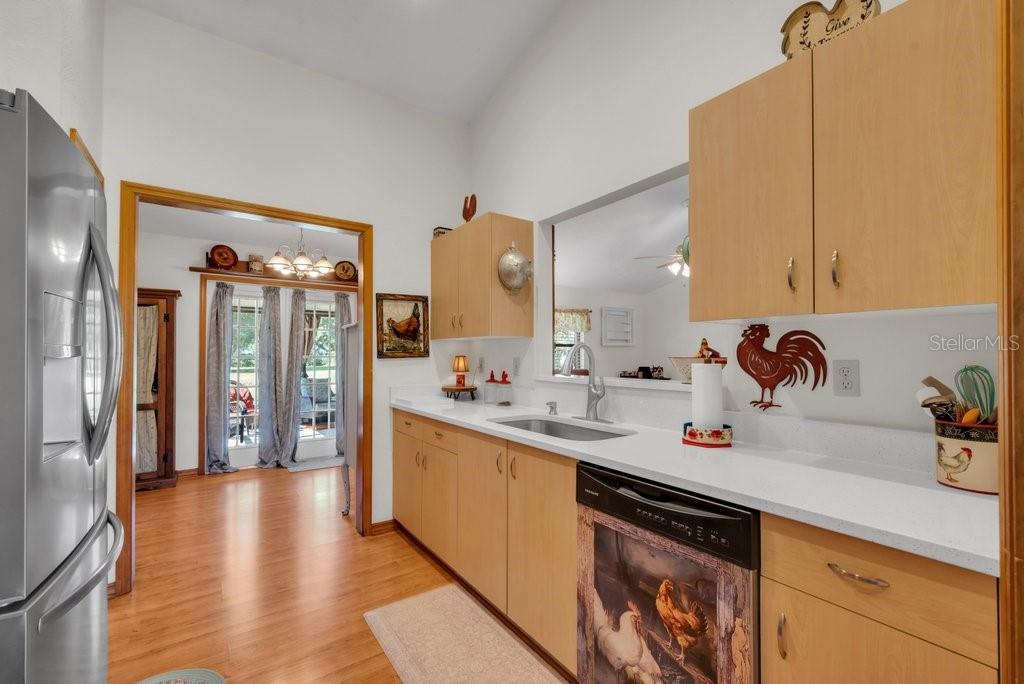 5301 Coronet Road Plant City, FL 33566 - Photo 25 of 38 a kitchen with stainless steel appliances a sink stove and cabinets