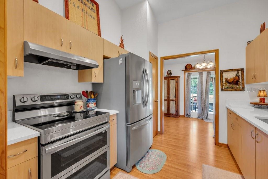 5301 Coronet Road Plant City, FL 33566 - Photo 26 of 38 a kitchen with stainless steel appliances a refrigerator and a stove top oven