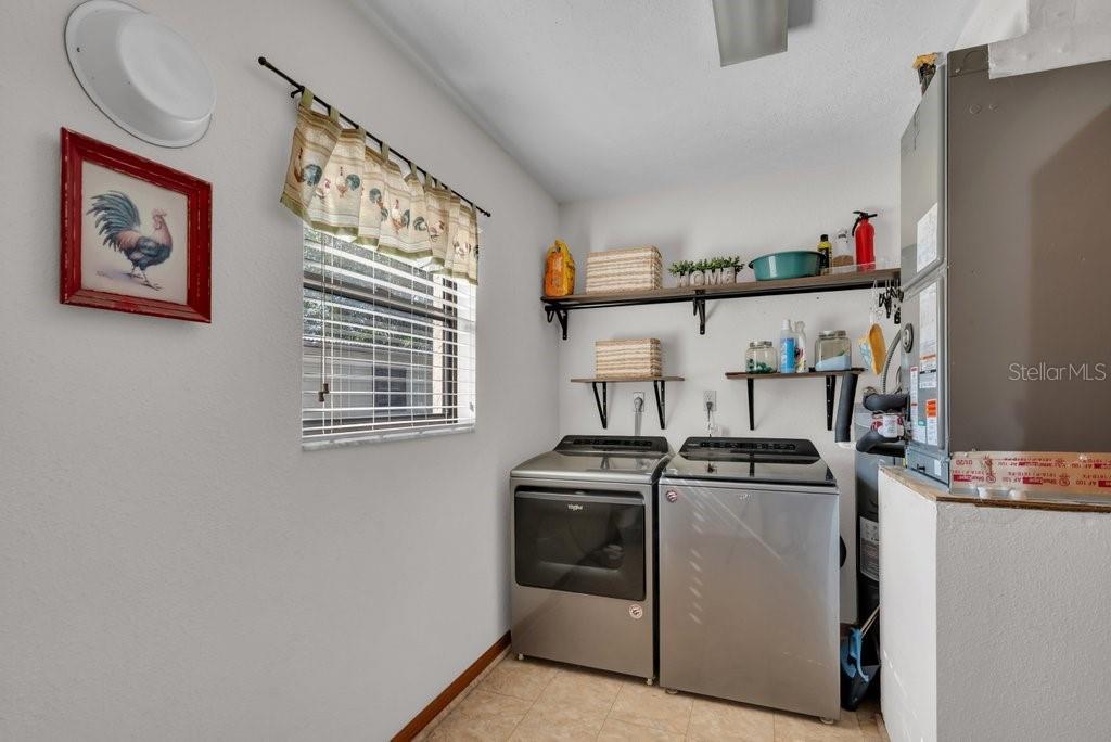 5301 Coronet Road Plant City, FL 33566 - Photo 28 of 38 a view of a kitchen with fridge and wooden floor