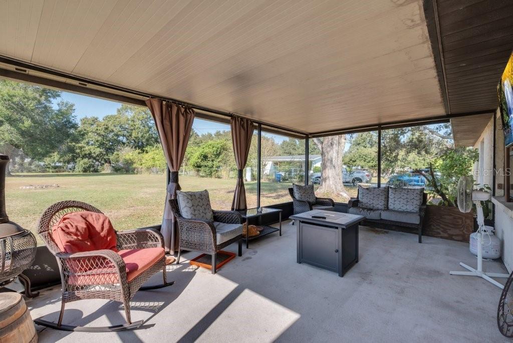 5301 Coronet Road Plant City, FL 33566 - Photo 29 of 38 a living room with furniture and floor to ceiling windows