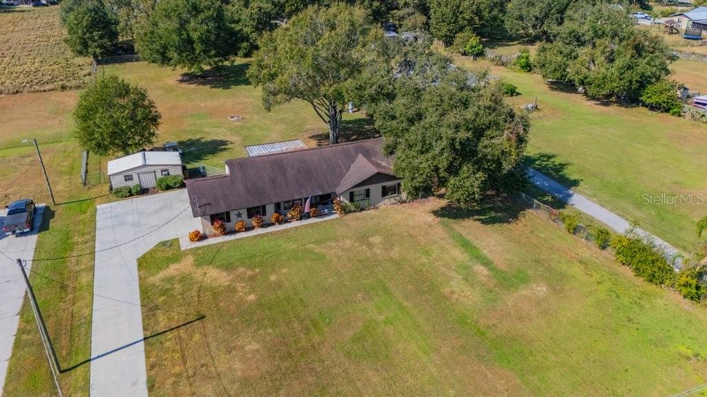 5301 Coronet Road Plant City, FL 33566 - Photo 4 of 38 an aerial view of a house with swimming pool and large trees