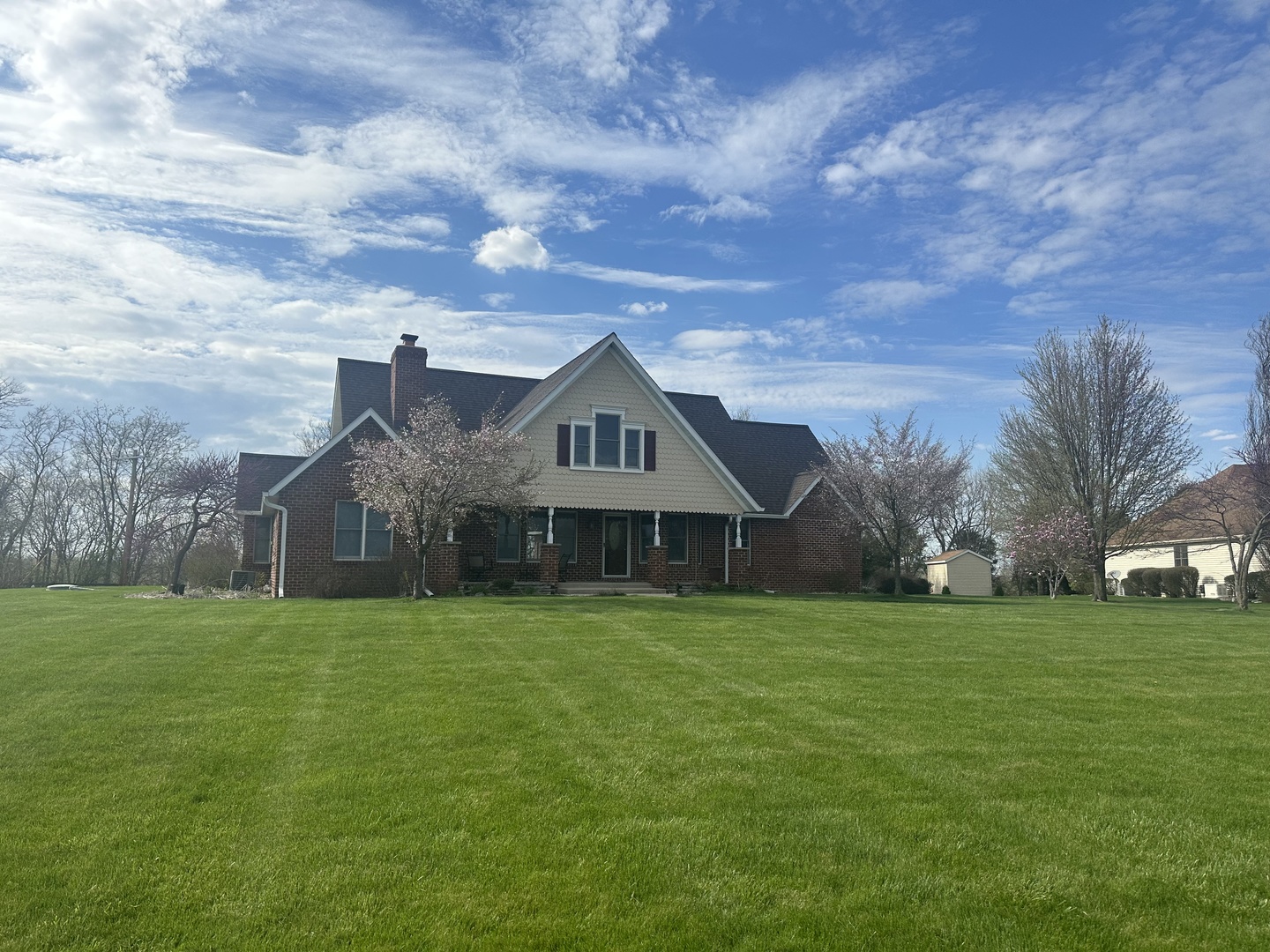 a front view of house with yard and green space