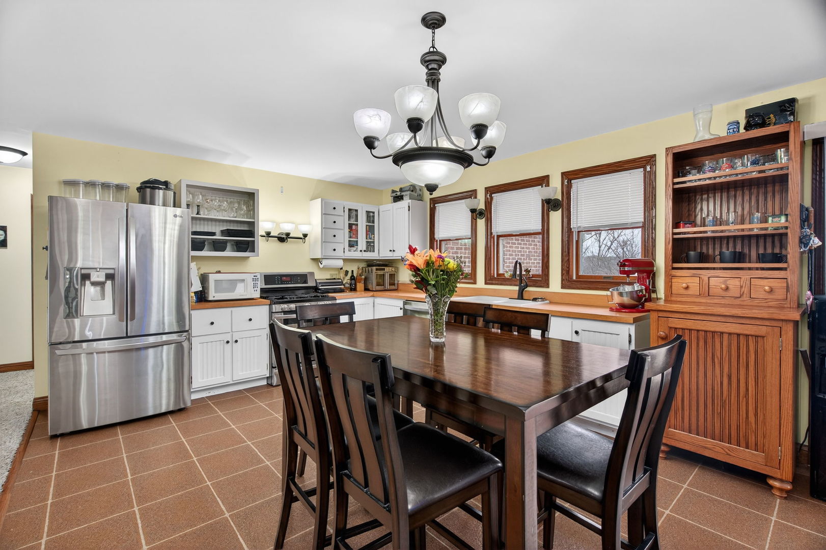 1707 North 2479th Road Ottawa, IL 61350 - Photo 8 of 30 a kitchen with stainless steel appliances granite countertop a dining table chairs refrigerator and cabinets