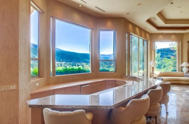 a bedroom with furniture and large windows