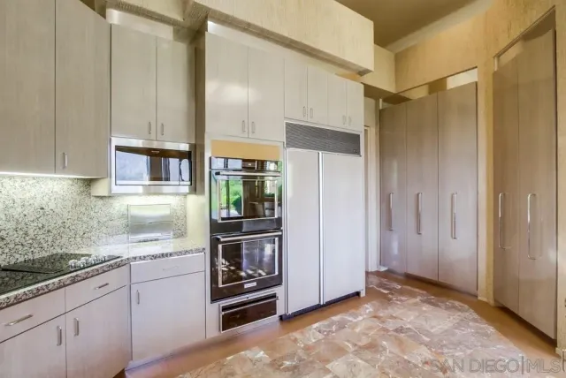 a kitchen with a sink and a large window