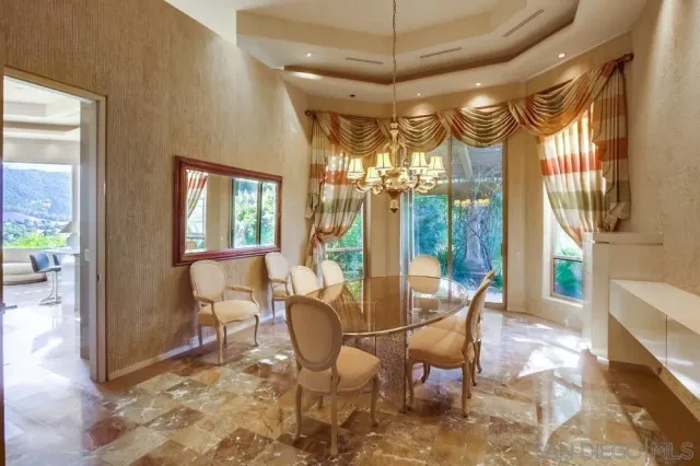 a dining room with furniture and a chandelier