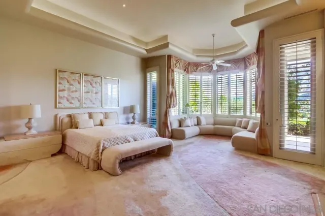 a bedroom with a bed and a large window