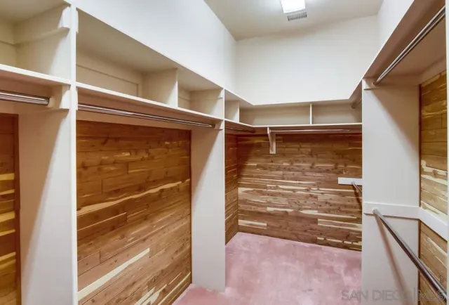 a bathroom with a tub a double vanity sink and a mirror