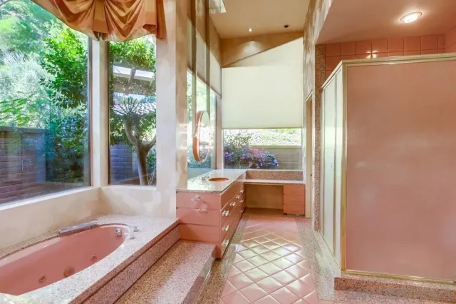 a bedroom with a bed and glass door