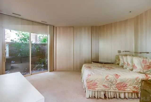 a living room with furniture a floor to ceiling window and a flat screen tv