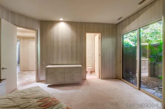 a living room with furniture a flat screen tv and a large window