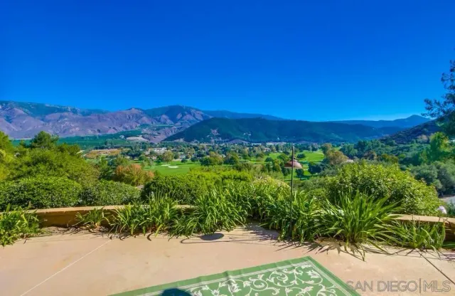a view of a town with mountains in the background