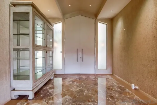 a living room with furniture and large windows