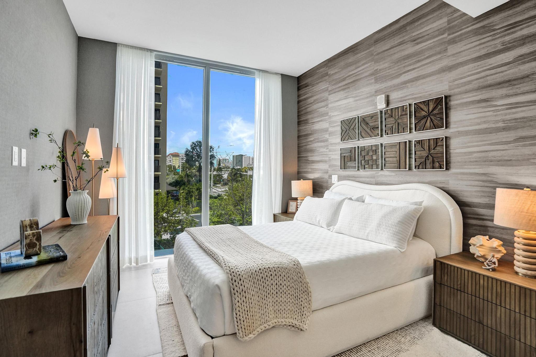 407 North Riverside Drive, Unit 203 Pompano Beach, FL 33062 - Photo 28 of 69 a bedroom with a bed and large windows