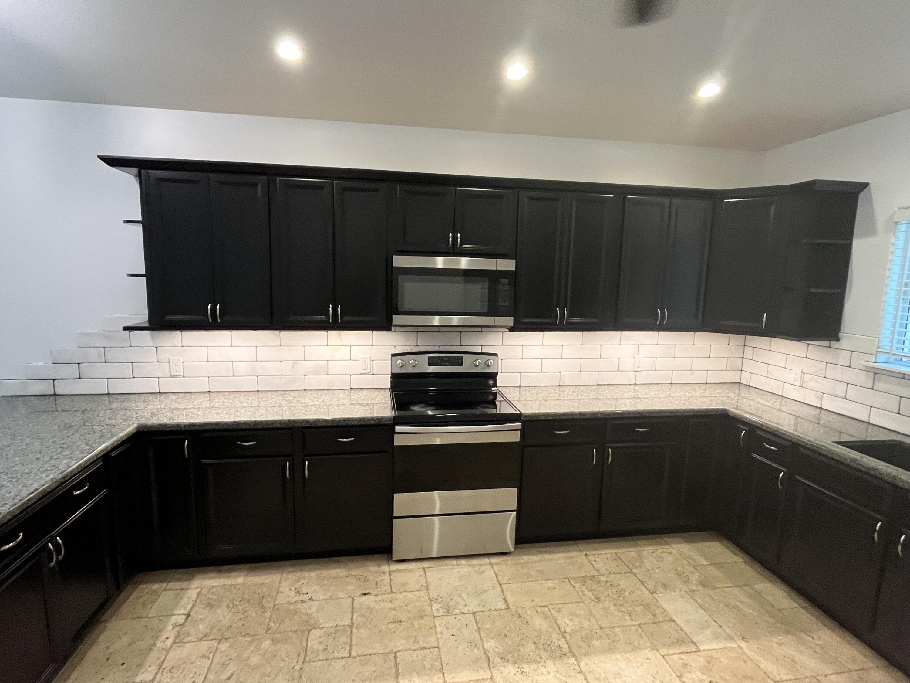 639 Cabrera Street Key Largo, FL 33037 - Photo 12 of 24 a kitchen with a sink and a stove top oven
