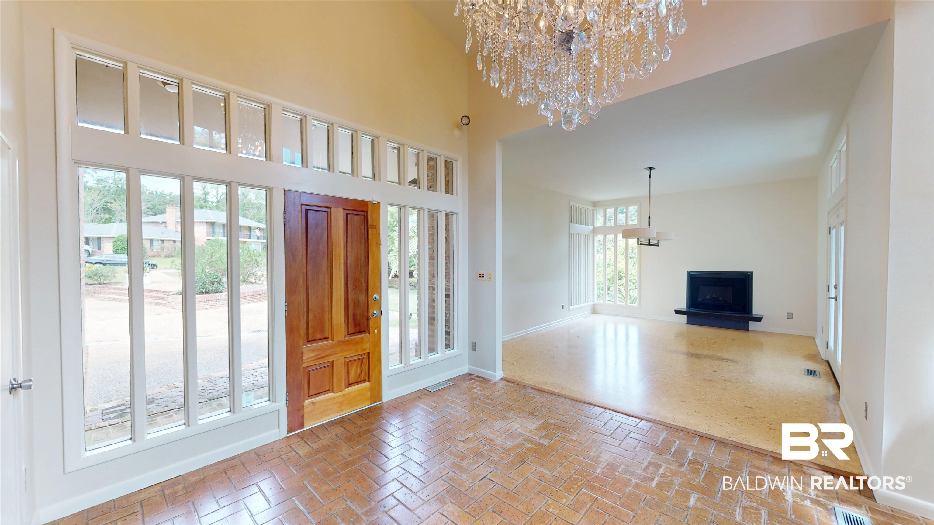 15 Spring Bank Road Mobile, AL 36608 - Photo 8 of 58 Foyer with brick floors, a chandelier, and a high ceiling