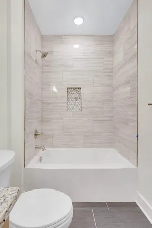 a bathroom with a bathtub and a toilet