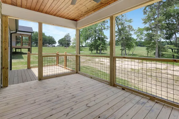 a view of porch with wooden floor