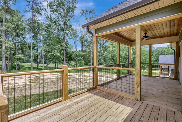a view of porch with wooden floor and floor to ceiling window