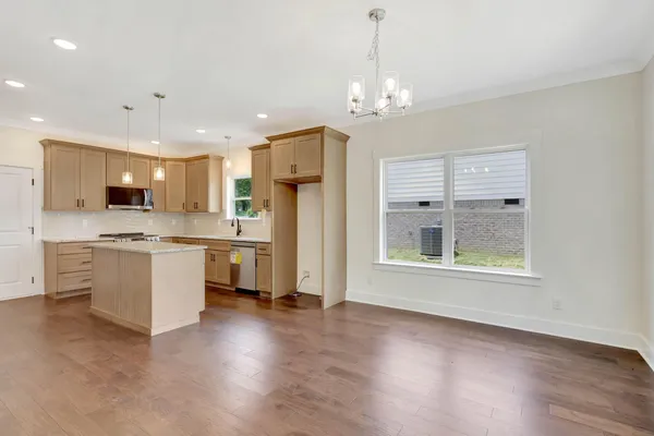 a view of a kitchen with a sink stainless steel appliances and cabinets