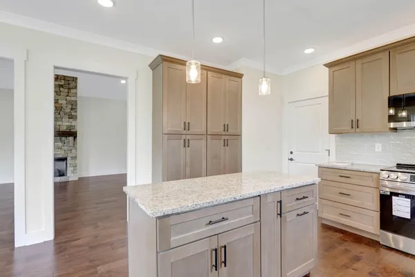 a kitchen with granite countertop white cabinets and stainless steel appliances