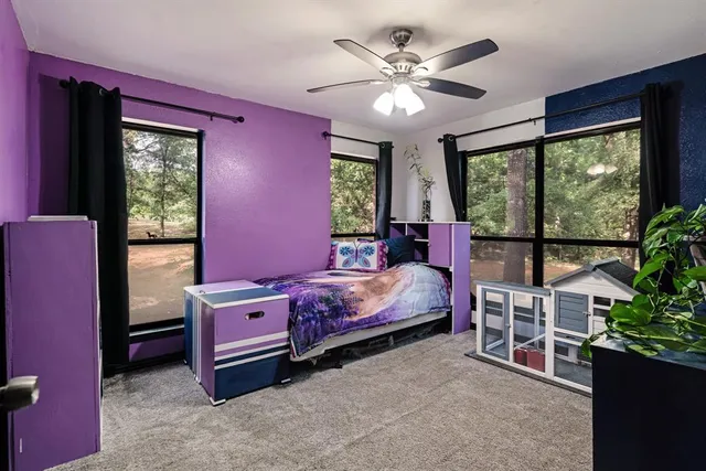 a bedroom with a bed and a large window