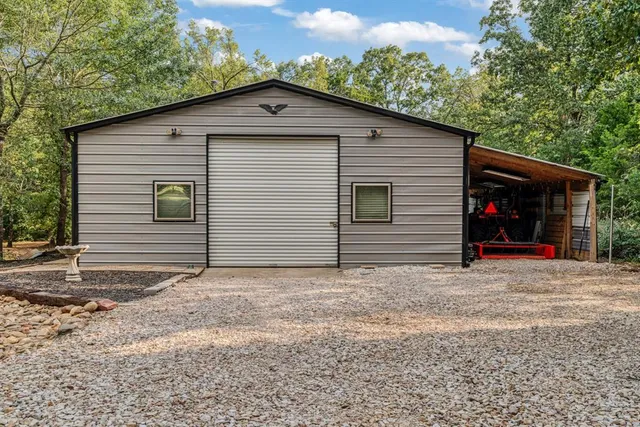 a view of a patio with table and chairs potted plants and floor to ceiling window