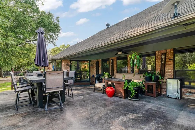 a view of a dining table and chairs in the patio