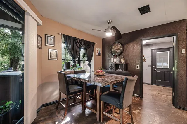 a view of a dining room with furniture and a chandelier