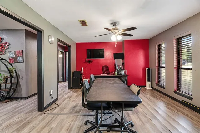 a bedroom with a bed dresser and a large window
