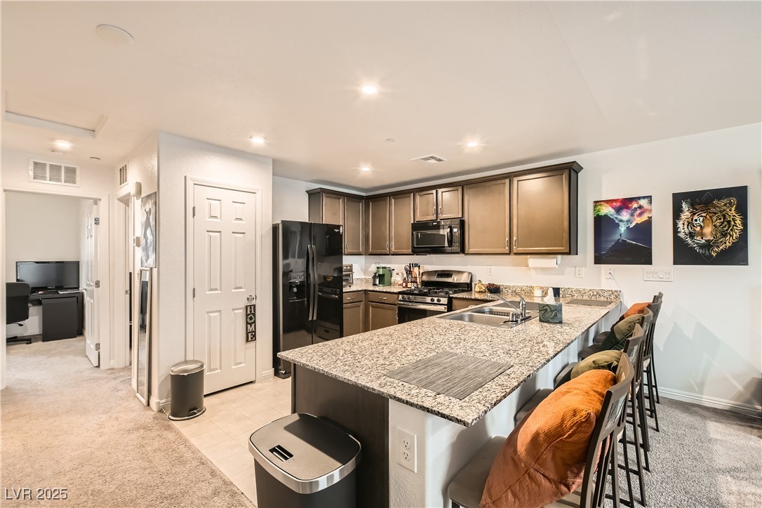 4602 Ingleton Circle Las Vegas, NV 89115 - Photo 2 of 11 Kitchen featuring visible vents, a sink, light sto