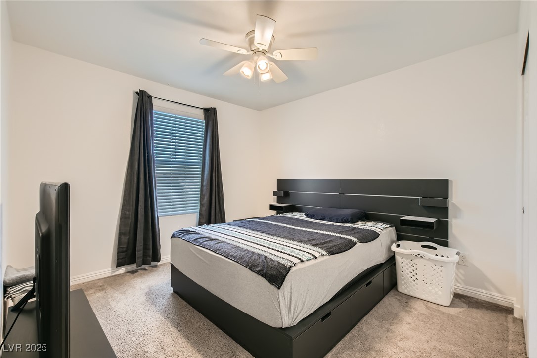4602 Ingleton Circle Las Vegas, NV 89115 - Photo 7 of 11 Carpeted bedroom featuring ceiling fan and baseboa