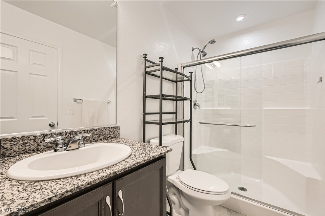 4602 Ingleton Circle Las Vegas, NV 89115 - Photo 8 of 11 Bathroom featuring tiled shower, vanity, and toile