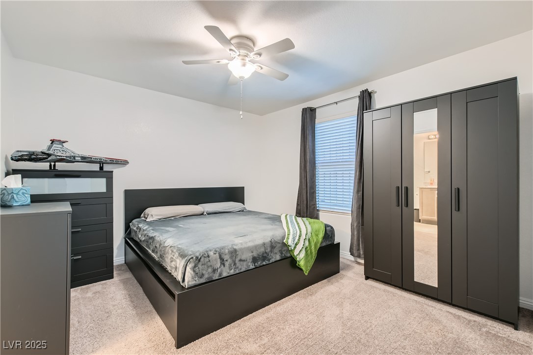 4602 Ingleton Circle Las Vegas, NV 89115 - Photo 9 of 11 Bedroom featuring light carpet, a ceiling fan, and