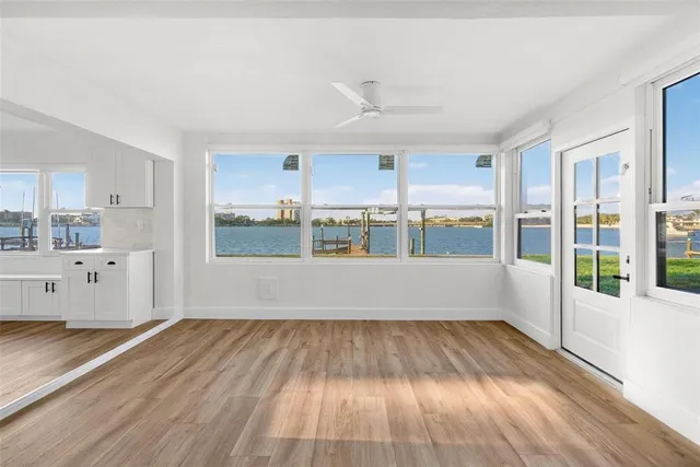 a view of kitchen with wooden floor and electronic appliances