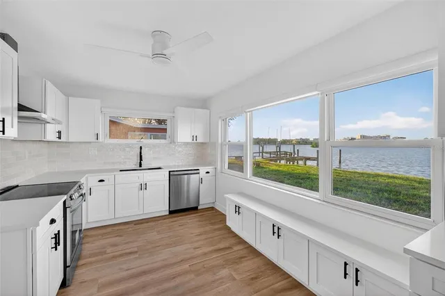 a kitchen with stainless steel appliances a stove sink and cabinets