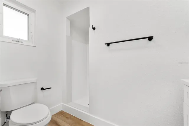 a bathroom with a toilet and a shower