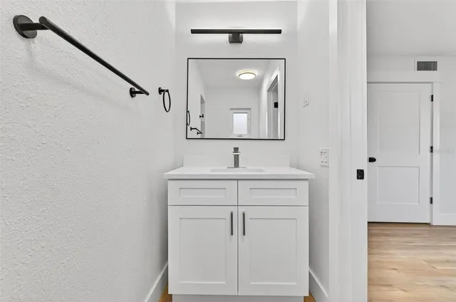 a bathroom with a sink a vanity and a mirror