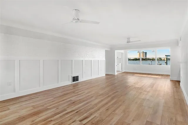 a view of empty room with wooden floor
